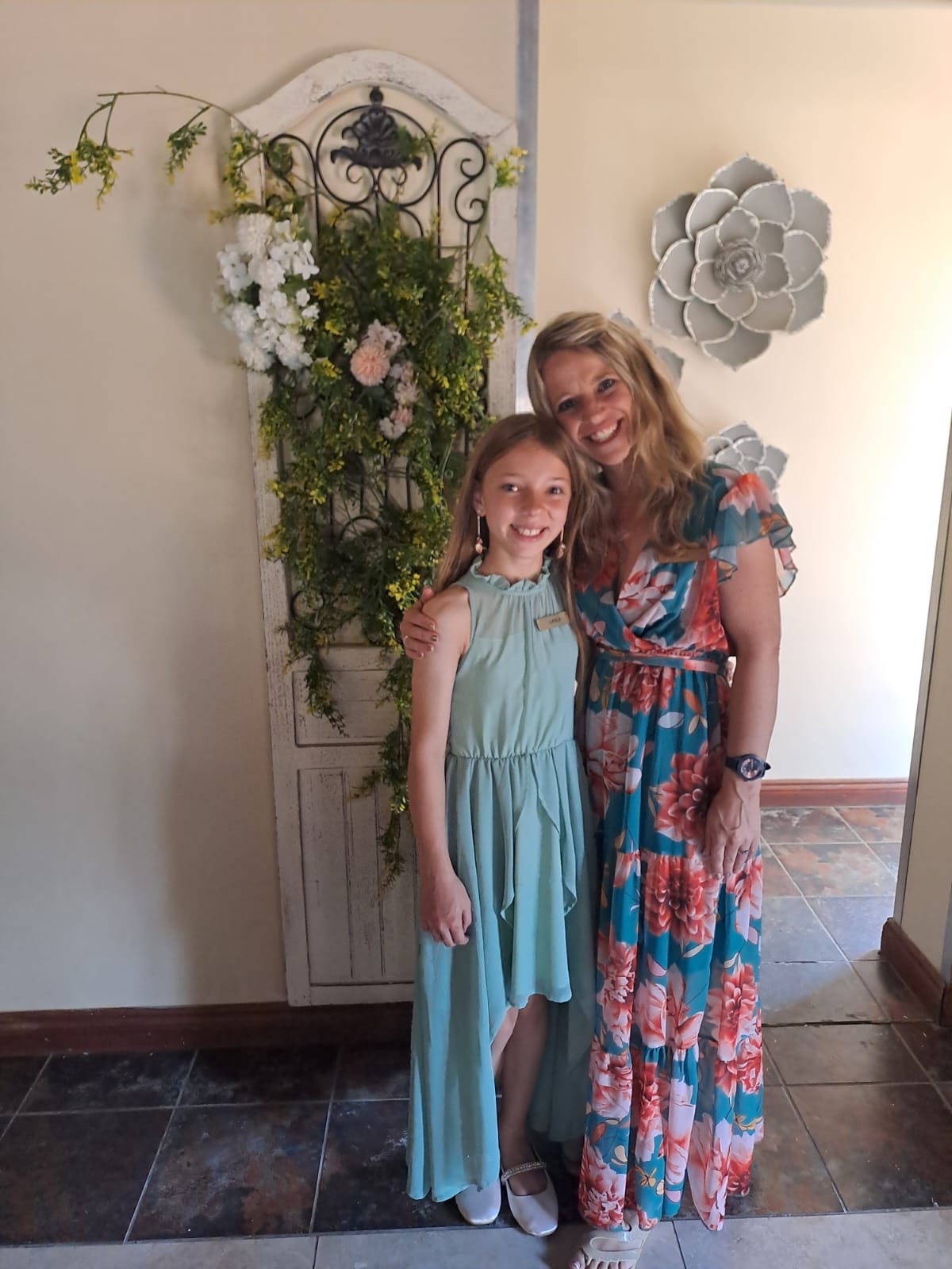 A mother and daughter dressed for celebration