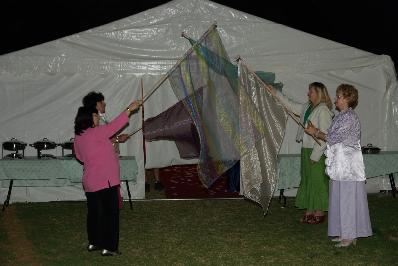 Worship flags outside the tent at dusk